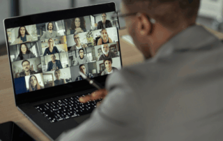 Professional attending a virtual event on a laptop