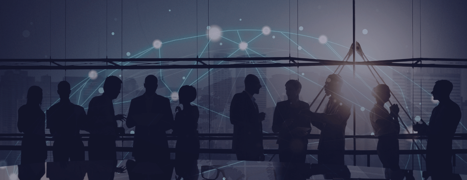 WhatIsGlobalSummit_BlogImage Blurred image of professionals at a global conference event.